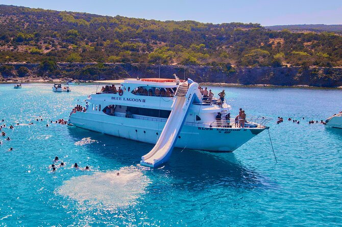 Blue Lagoon (Akamas) Bus & Boat Tour with Water Slide From Paphos - Blue Lagoon time: swimming expectations, salty water, and the stairs bottleneck