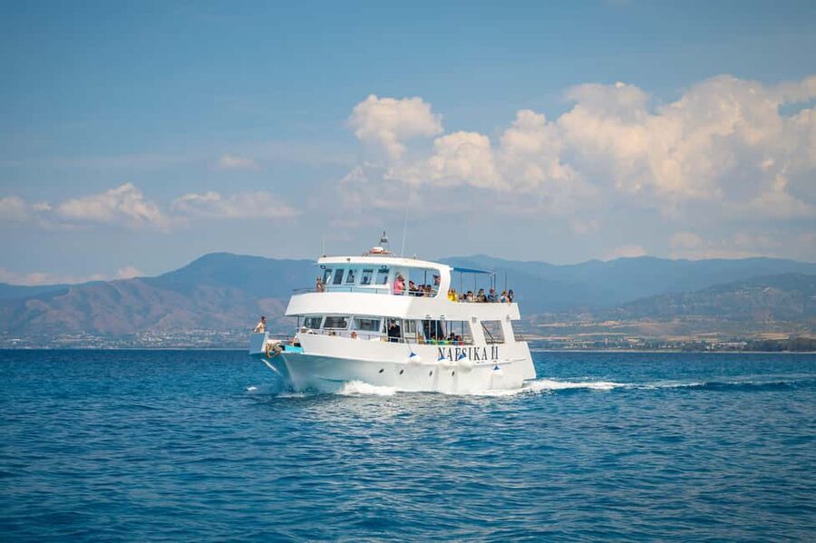 Paphos: Blue Lagoon Afternoon Cruise with Swim, BBQ & Wine - Sunset over the water, plus the onboard vibe after dinner