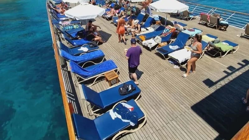 Paphos: Wave Dancer Sunset Cruise with BBQ and Swimming - The deck game: where to sit for shade, views, and photos