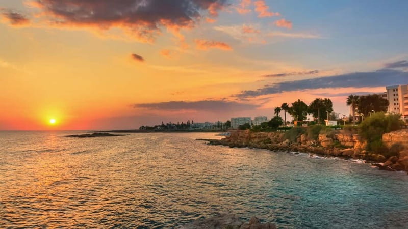 Protaras: Blue Lagoon, Sea Caves and Turtle Cove Sunset Trip - Cape Greco sea caves and Lover’s Bridge, from a boat angle